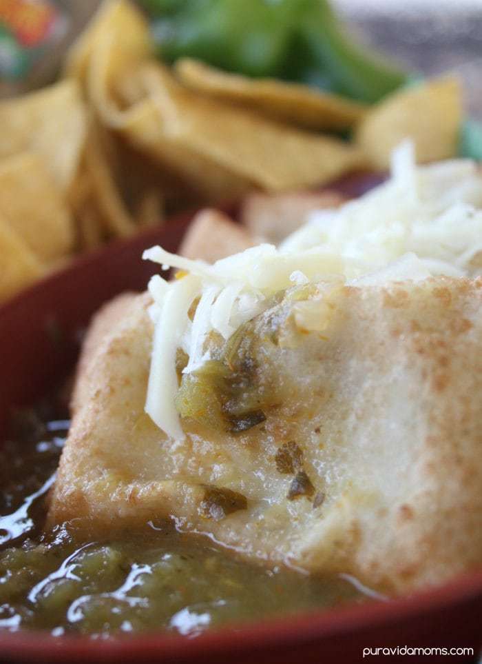 Close up of game day chile rellenos smothered in chile verde.
