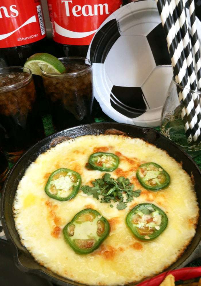 Baked cheese dip served in a small cast iron pan.