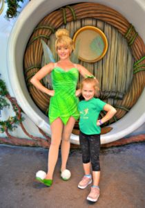 Young girl wearing a DIY shirt posing with Tinkerbell performer.