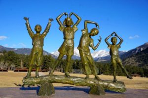 Golden statue of four posing children at the YMCA of the Rockies.