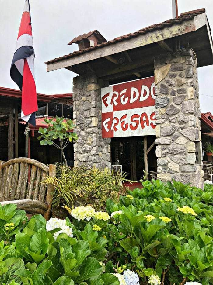 Stone and painted wood sign for Freddo Fresas Restaurant Poas.