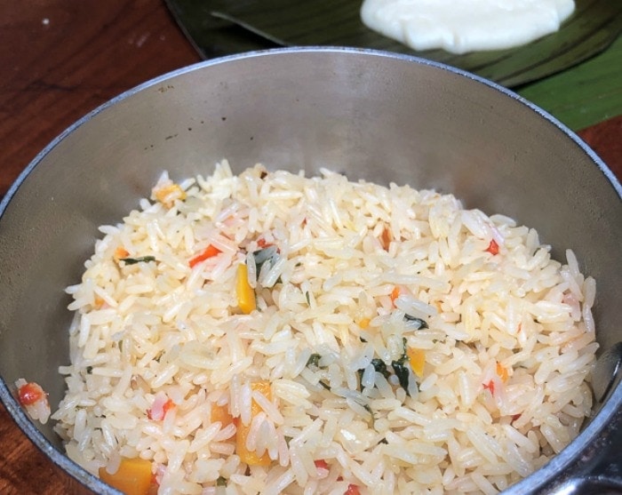 Costa Rican rice in a large stockpot with vegetables and spices.