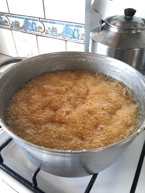 Costa Rican candy boiling on gas stove.
