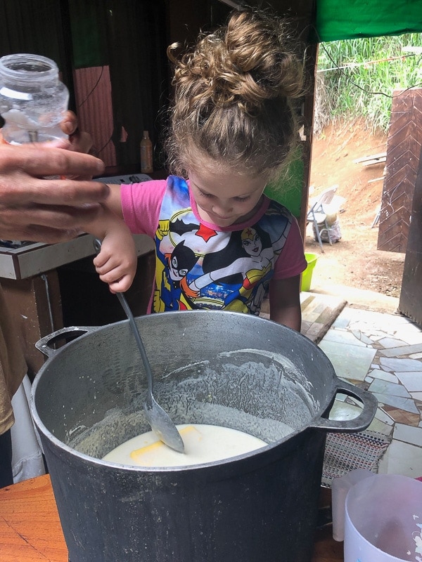 young girl stirring large pot of tamale masa in Costa Rica
