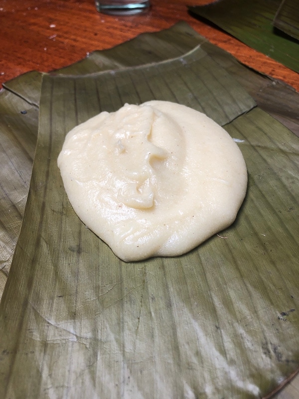 half cup of tamale masa on a plantain leaf in costa rica