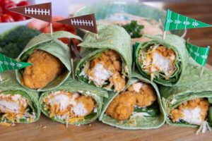 Buffalo chicken wraps with football flag toothpicks speared into them.
