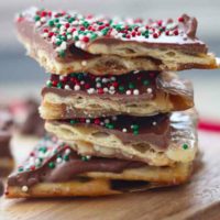 broken up saltine crackers of Christmas crack stacked on top of each other.