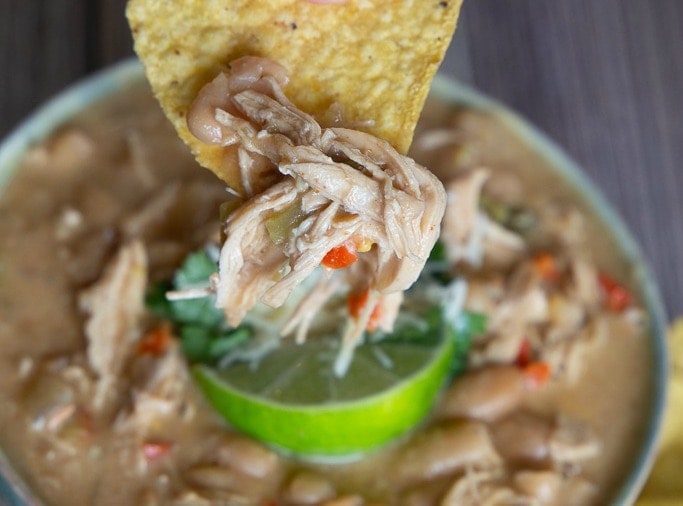 How to make a bowl of chili- chicken, sour cream, lime and great northern beans.