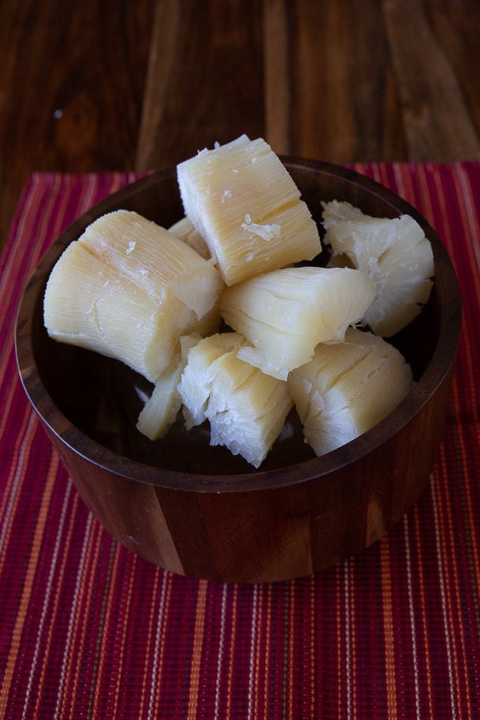 costa rican boiled yuca in a wooden bowl on a placemat