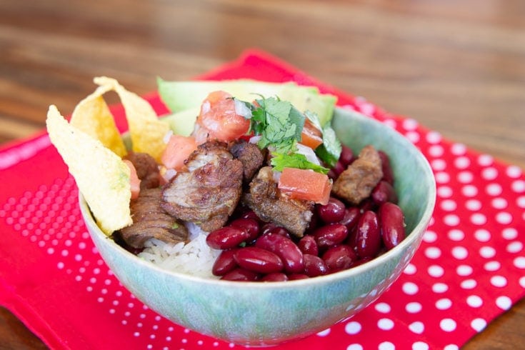 Traditional Costa Rican chifrijo kidney beans, chicharron, white rice, avocado and totilla chips.