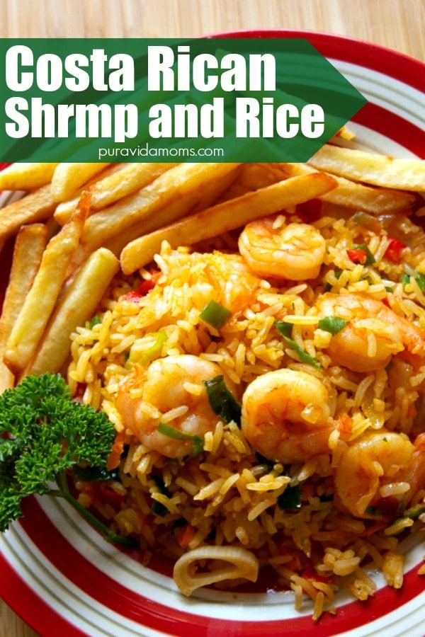 shrimp, and rice in a bowl garnished with seasoning..