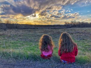 Two girls admiring a sunset.