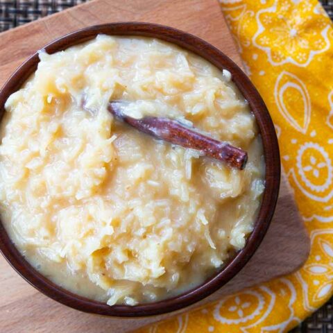 Bowl full of miel de coco on a yellow cloth.
