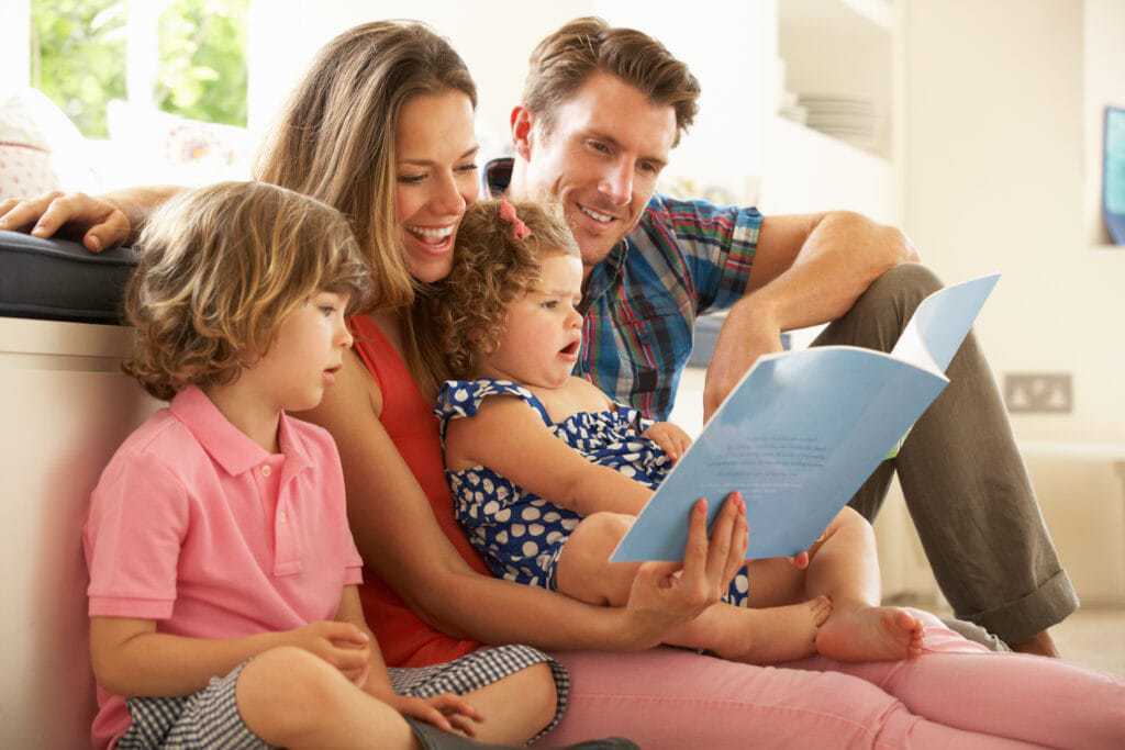 Four-person family enjoying a story.