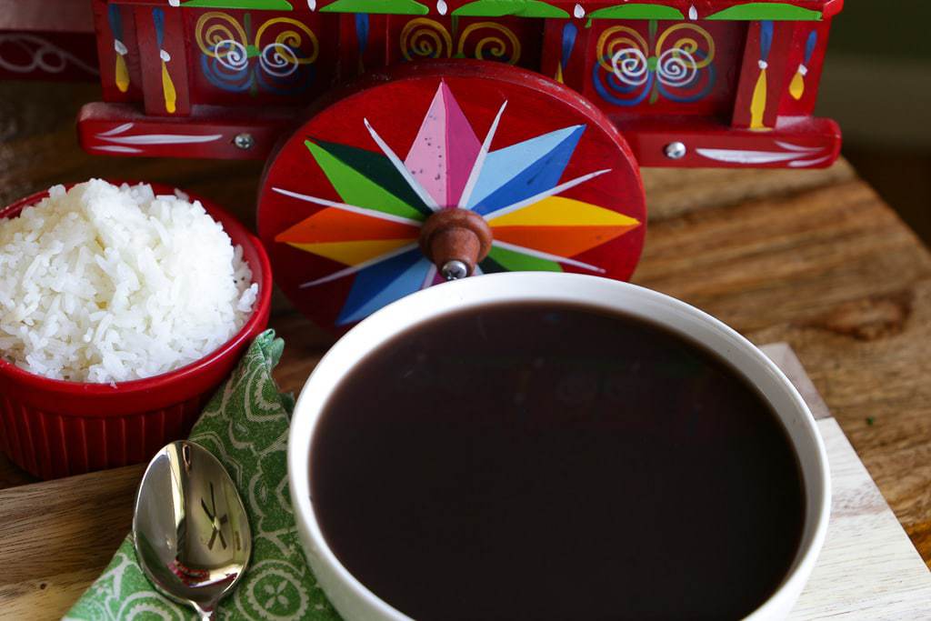 small bowl of white rice, black bean soup and red ox cart