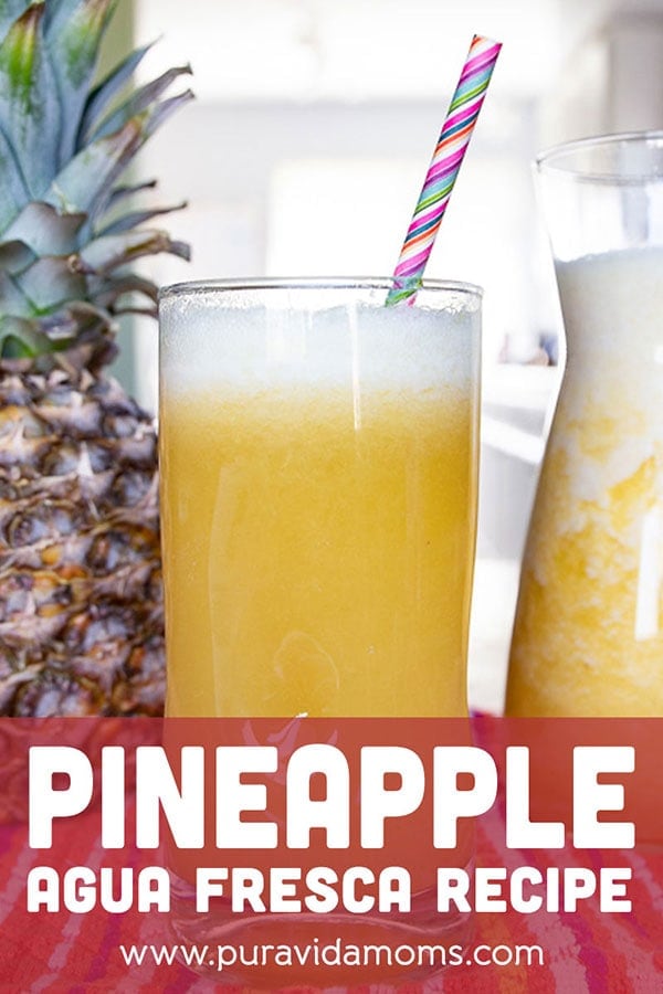 A tall glass of the pineapple Fresca with a straw.