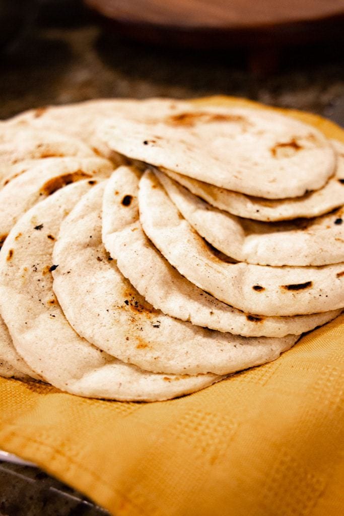 Ring of Costa Rican tortillas on a yellow cloth.