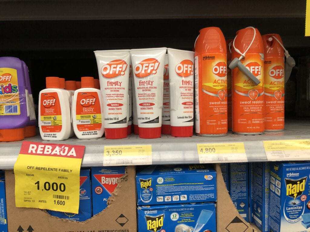 cans and bottles of mosquito repellent on a shelf