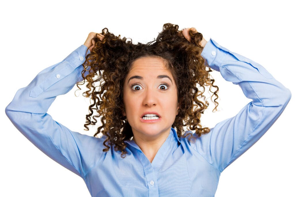 woman pulling her hair out, frustrated parent