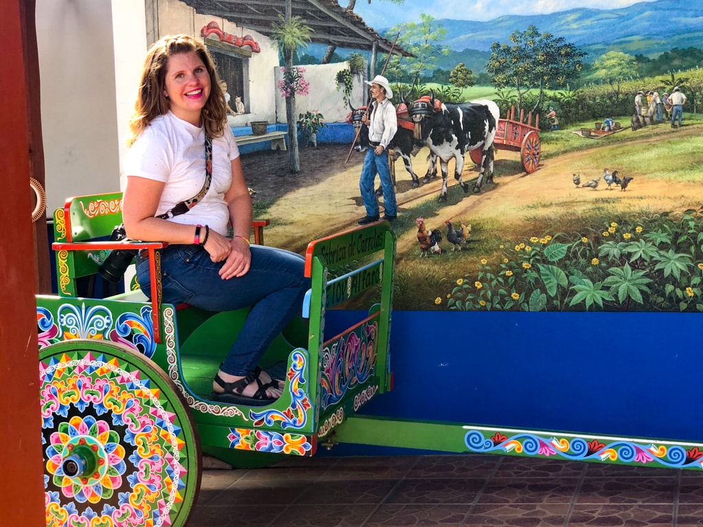 Christa sitting in sarchi costa rica pianted ox cart