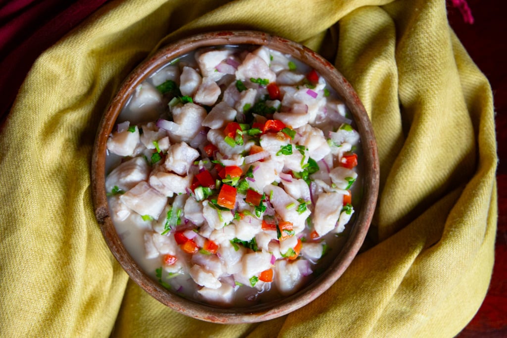 Fish ceviche in a brown serving bowl.