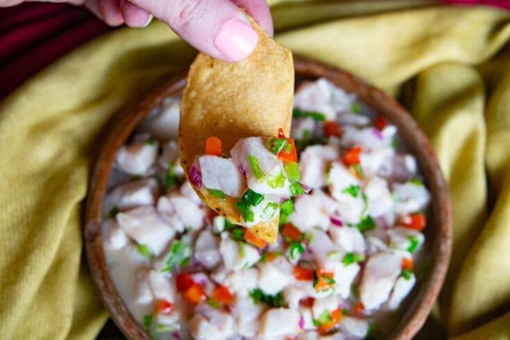 Dipping a chip into fish ceviche.